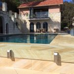 Frameless glass pool fence around a sandstone pool in Adelaide