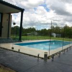 Frameless glass pool fence beside a modern Adelaide home