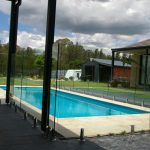 Frameless glass pool fencing with lawn surrounds
