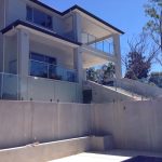 Frameless glass balcony balustrade on a two-storey home