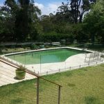 Resort-style pool with frameless glass fencing